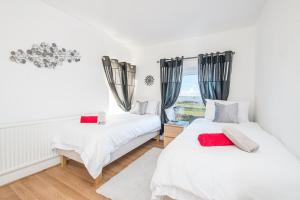 zwei Betten in einem Zimmer mit Fenster in der Unterkunft Llwyndyrys in Haverfordwest