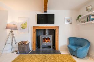 sala de estar con chimenea y silla azul en 7 Prendergast, en Haverfordwest