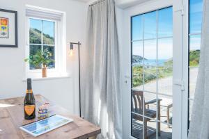 ein Esszimmer mit Tisch und Blick auf das Meer in der Unterkunft Ty Olwen in Haverfordwest