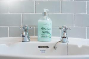 a bottle of aloe vera soap sitting on a sink at Drws Gobaith-West in Haverfordwest +32 photos
