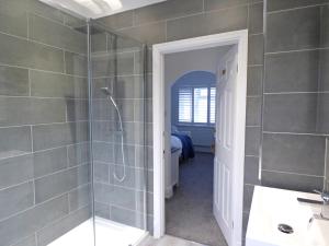 a bathroom with a shower and a walk in shower at The Rath in Saundersfoot +32 photos