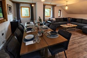 a dining room with a table and chairs and a couch at Spago am Hochkönig in Mühlbach am Hochkönig