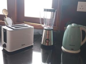 a blender and a toaster sitting on a counter at Green Corridor - Ahangama in Ahangama