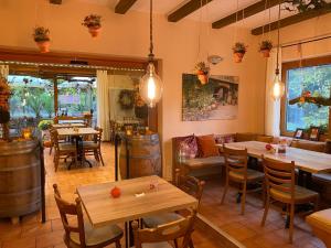 a restaurant with tables and chairs and wine barrels at Ferienwohnungen Park Café am Kurpark in Bernkastel-Kues