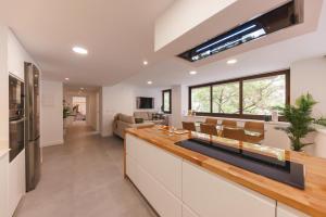 a kitchen with a counter and a living room at Bravissimo Turbau Entresol A, with 3 bedrooms in Girona