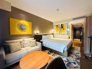 a hotel room with a bed and a couch at Hotel Residences near Makati in Manila +40 photos
