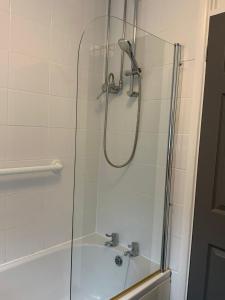 a bathroom with a shower with a glass door at Light and airy cosy bungalow in Draycott +26 photos