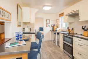 a kitchen with a table and a counter top at Afallon in Haverfordwest
