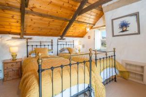 a bedroom with a bed and a wooden ceiling at Lower Porthmawr in Haverfordwest
