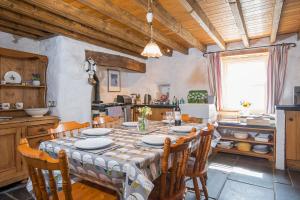 a dining room with a table and chairs in a kitchen at Lower Porthmawr in Haverfordwest