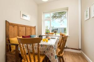 a dining room with a table and chairs and a window at Gorwel in Haverfordwest