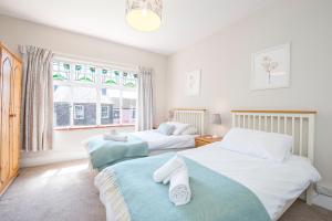 a bedroom with two beds and a window at Gorwel in Haverfordwest