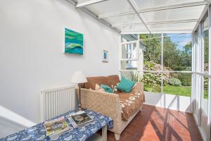 a living room with a couch and a window at Willowcot Cottage in Haverfordwest +17 photos