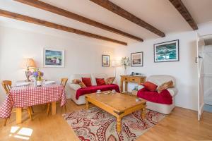 a living room with a couch and a table at Willowcot Cottage in Haverfordwest