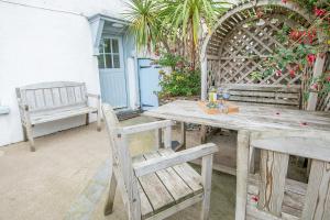 a wooden table and chairs on a patio at Lower Deck in Tenby