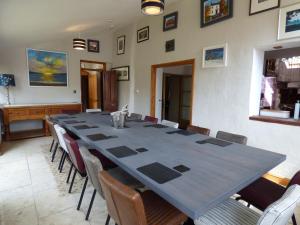 a conference room with a long table and chairs at Glebe House in Haverfordwest