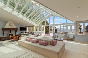 a bedroom with a large bed in a room with windows at Waterwynch House in Tenby