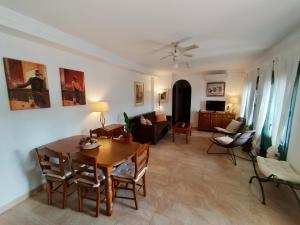 a living room with a table and a couch at La vista encantada in Frigiliana