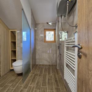 a bathroom with a shower and a toilet in it at Trebevićki Raj in Brus