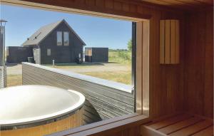 a bathroom with a large window and a tub at Three-Bedroom Holiday Home In Romo in Sønderby +25 photos