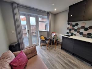 a living room with a couch and a table at Boutique Annexe Close To Central Norwich & Airport in Norwich