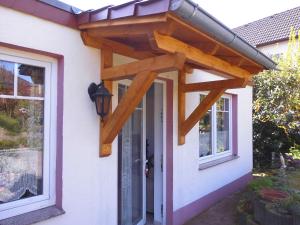a wooden pergola on the side of a house at Marie's Apartment in Detmold +7 photos