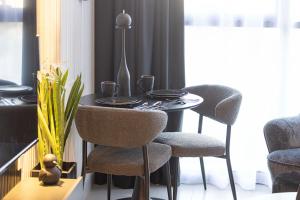 a dining room with a table and two chairs at 1BR Private Apartment in Center of Sharjah- Black Knight in Sharjah