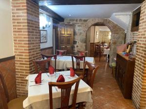 a restaurant with tables and chairs with red pillows on them at San Miguel in Segovia