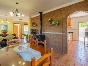 a living room with a table and a brick wall at Cubo's Casa Rural Huertas Viejas High Privacy in Coín