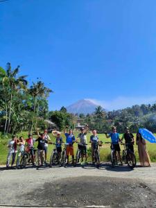 a group of people on bikes on a road at Indah Damai Cottages in Sidomukti