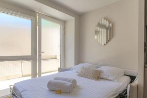 a bedroom with a bed with two towels on it at Studio with sleeping area for 4, Saint-Didier in Saint-Didier-au-Mont-dʼOr