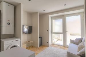 a living room with a couch and a window at Studio with sleeping area for 4, Saint-Didier in Saint-Didier-au-Mont-dʼOr +3 photos