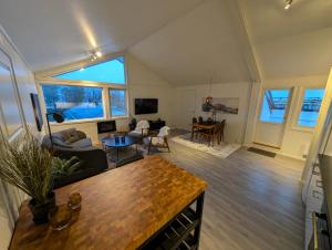 a living room with a couch and a table at Reine City Apartment in Reine