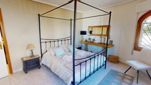 a bedroom with a canopy bed and a mirror at Villa Marqués in Ciudad Quesada +39 photos