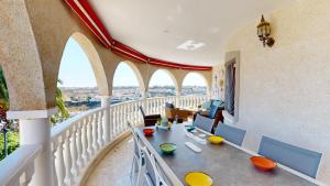 a room with a balcony with a table and chairs at Villa Marqués in Ciudad Quesada