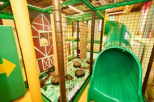 a cage with a green parrot in it at Sonnberg Ferienanlage in Flachau