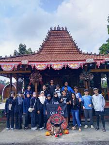 a group of people standing in front of a building at Indah Damai Cottages in Sidomukti