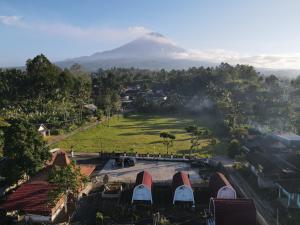 an aerial view of a mountain with houses and trees at Indah Damai Cottages in Sidomukti