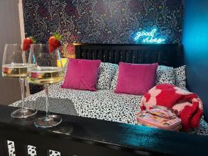 a room with a bed with two glasses of wine at Boutique Annexe Close To Norwich City & Airport in Horsham Saint Faith