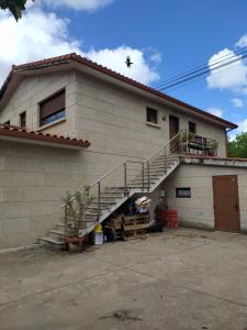 a house with a staircase on the side of it at A Nogueira in Tui