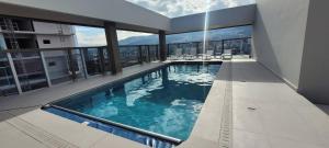 a swimming pool in the middle of a building at Le Parc Residence Deluxe Suite in Quito