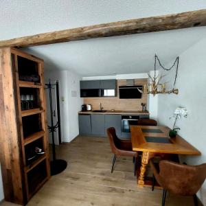 a kitchen and dining room with a table and chairs at FeWo's und Apartment's Schöneck in Davos