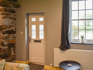 a living room with a door and a window at Doddick Beck - Uk39153 in Threlkeld