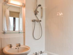 a bathroom with a sink and a shower at May Cottage-Uk38279 in Cloughton