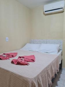 a bed with pink towels on top of it at Hotel Veleiro de Porto in Porto De Galinhas +28 photos