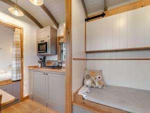 a small kitchen with a bench in a tiny house at The Swaledale Hut - Uk40151 in Rathmell