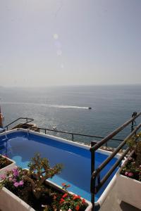 a swimming pool with a view of the ocean at Villa Margi in Vico Equense