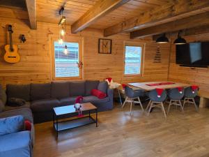 a living room with a couch and a table at Chalet Fiona with jacuzzi in Mýto pod Ďumbierom