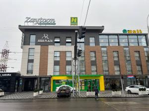 a building on a street with cars parked in front of it at Arda Plaza Hotel in Tashkent