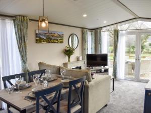 a living room with a table and a couch at Dodd - Uk42499 in Bassenthwaite